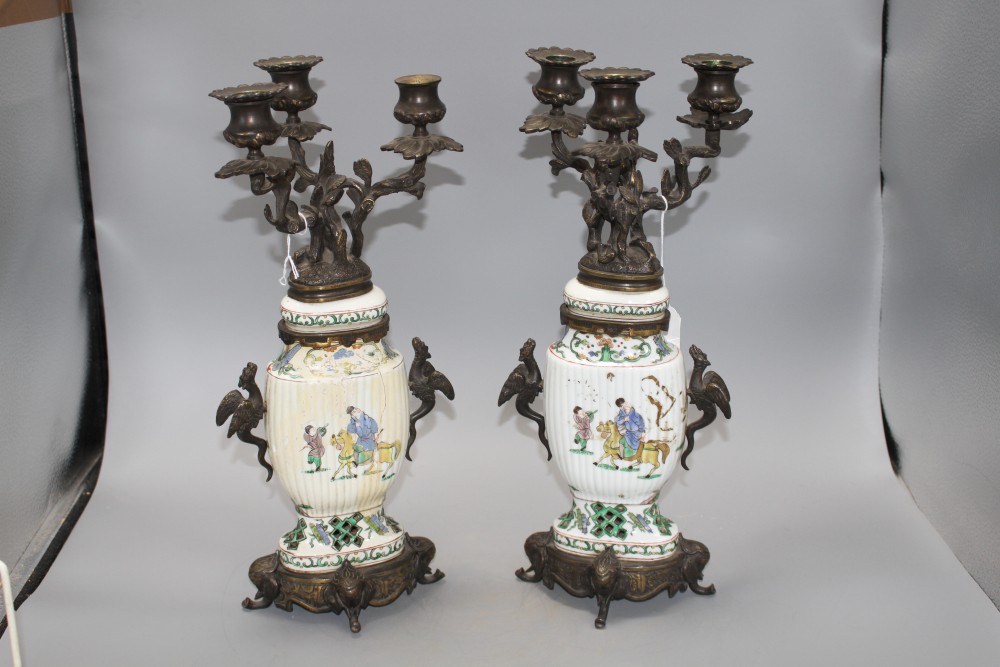 A pair of Samson famille verte style bronze mounted candelabra, with rustic branches and dragon handles, height 41cm